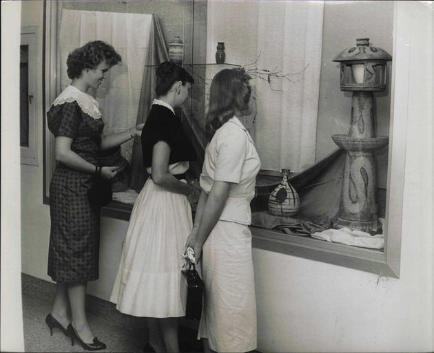 Students viewing a ceramic art exhibit at the Fine Arts area